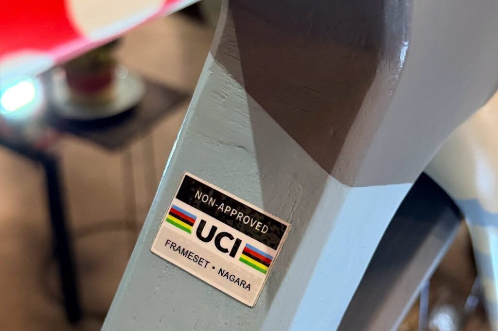 Bicycle frame badge reading: 'UCI non-approved'